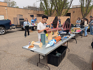 one student looking at a rocket